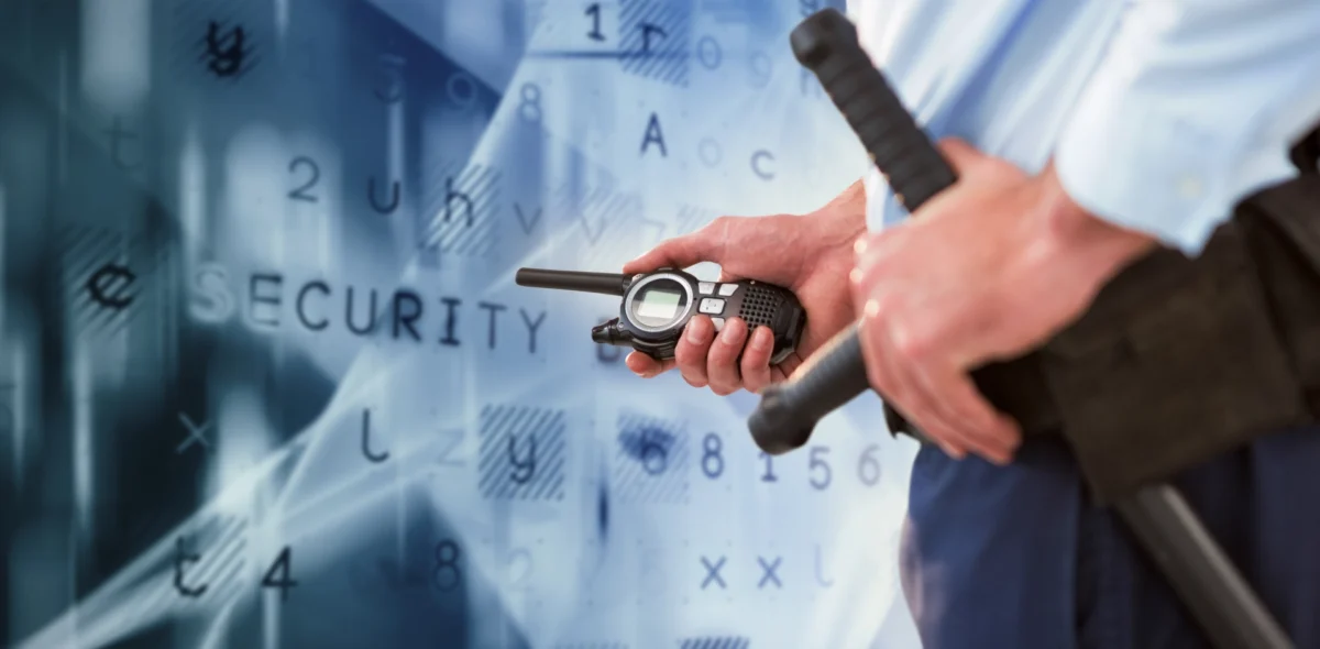 Security officer holding walkie-talkie and baton against digital security background, representing physical security in 2025