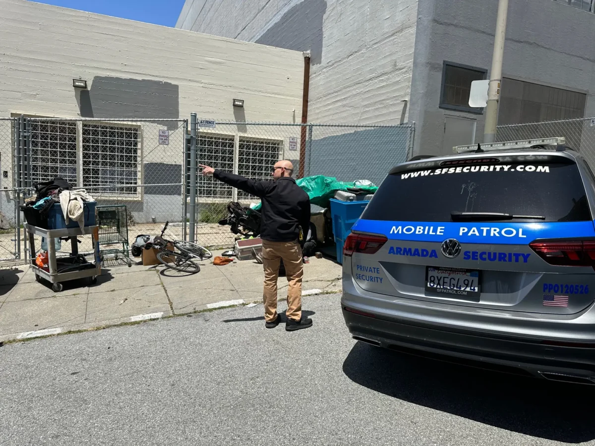 Security officer addressing encampment issue at educational institution in San Francisco